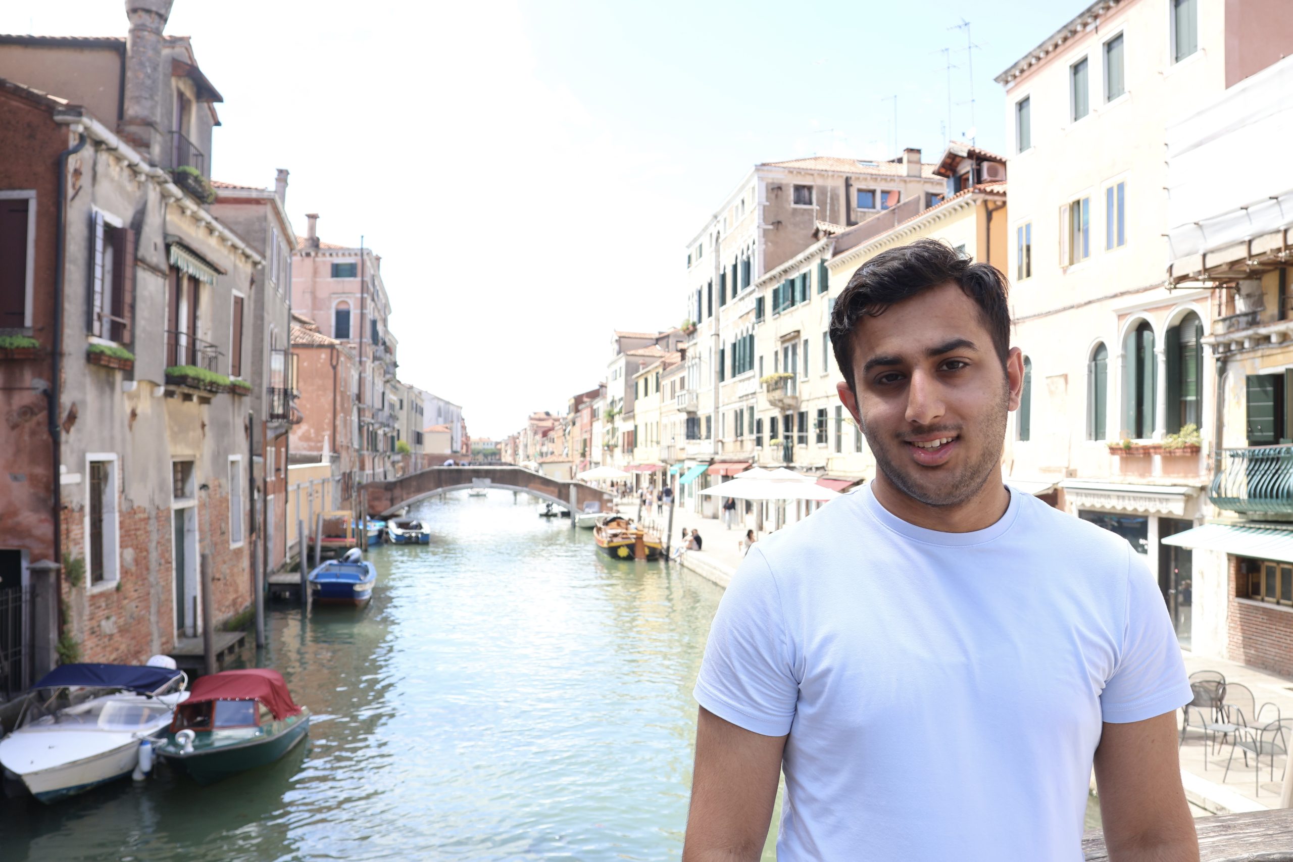 Umer standing beside a canal in Venice.