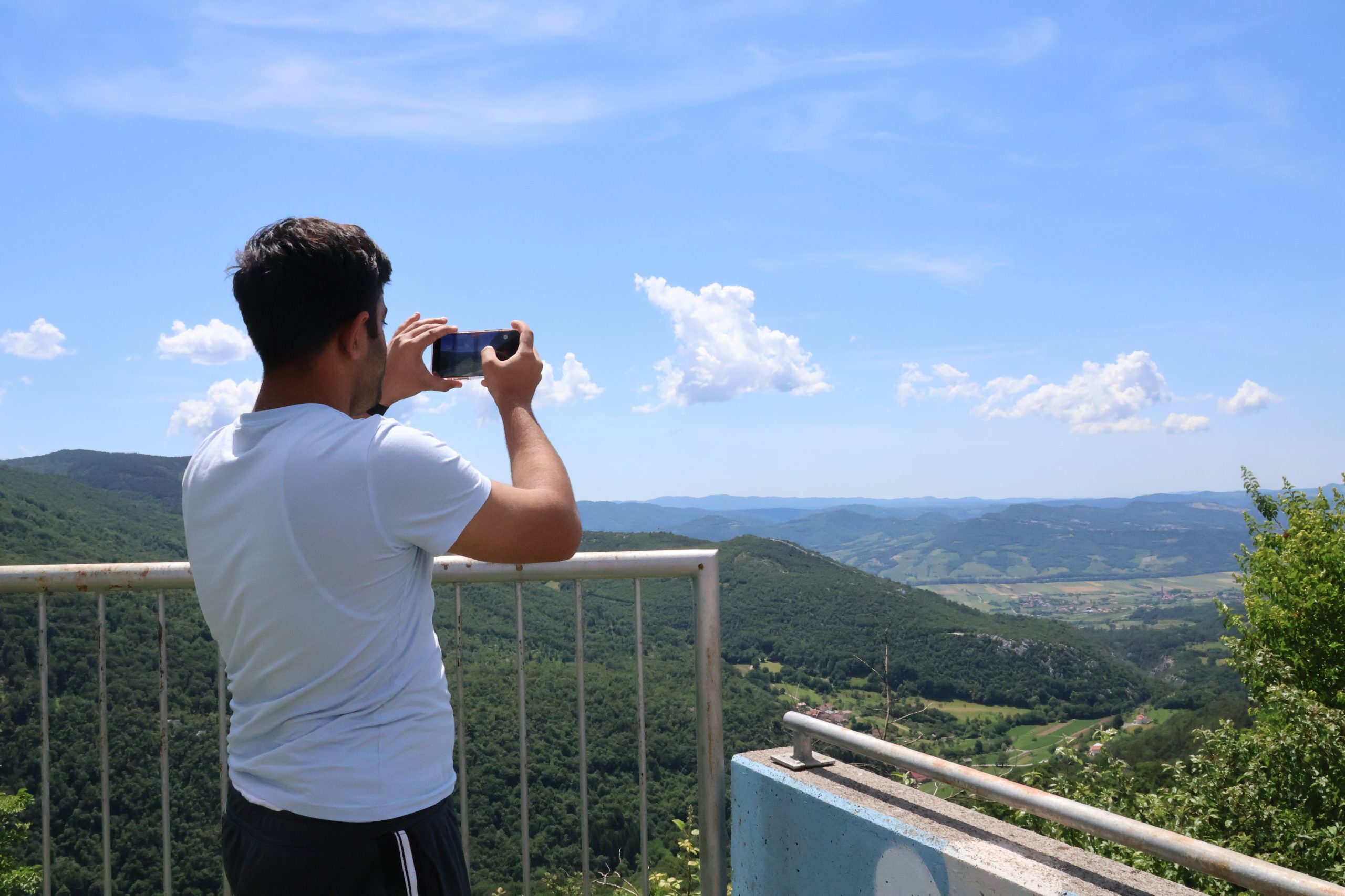 Umer taking a photograph of the mountains in Slovenia.