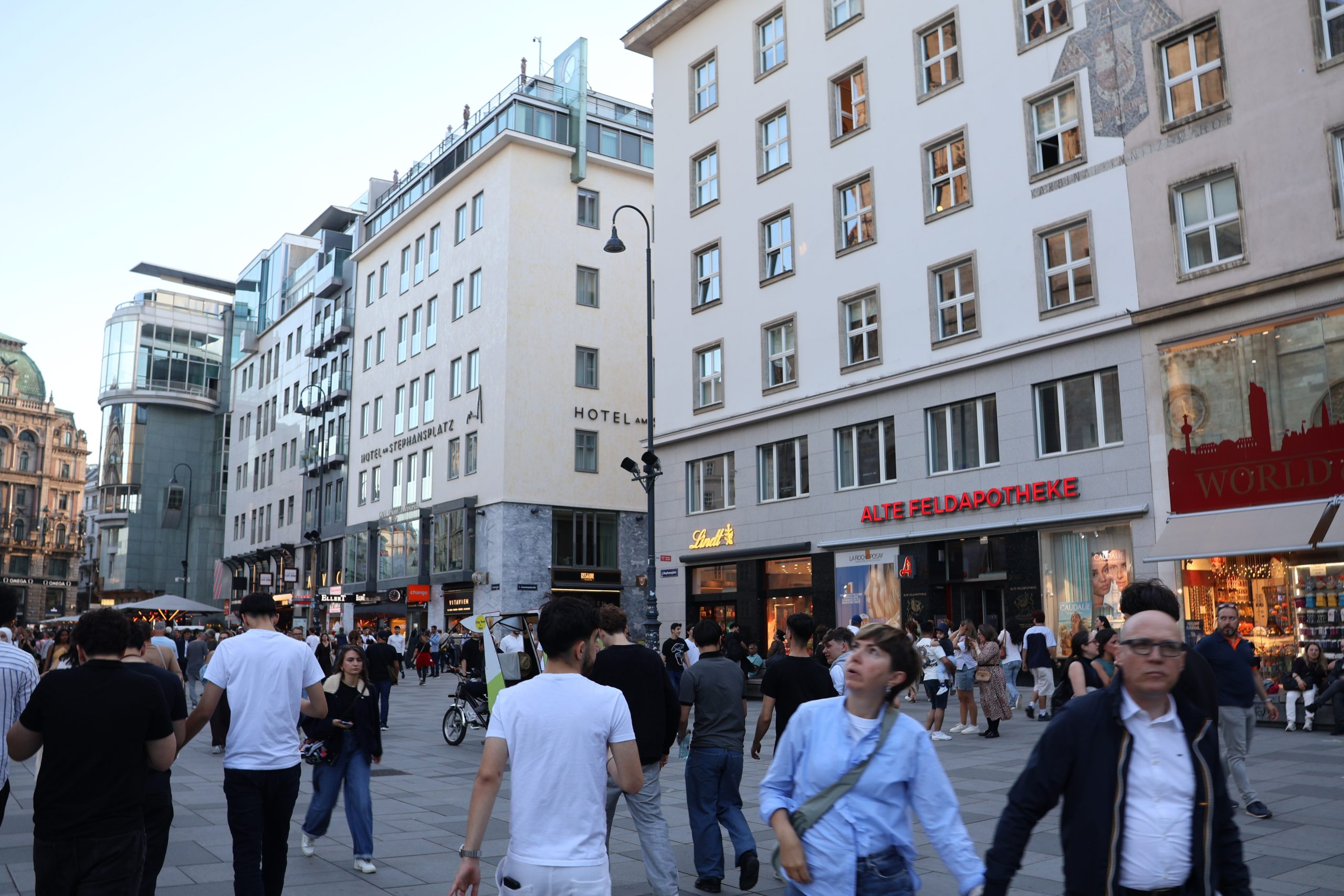 A city street in central Vienna illuminated at night.