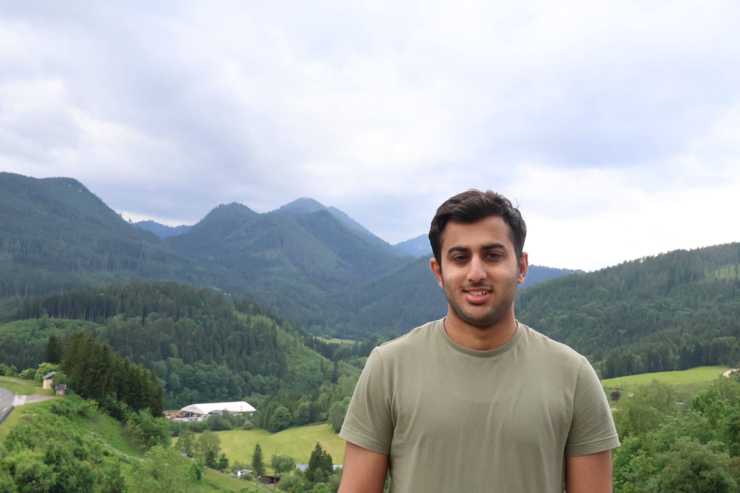 Umer standing with the mountains of Mariazell behind him.