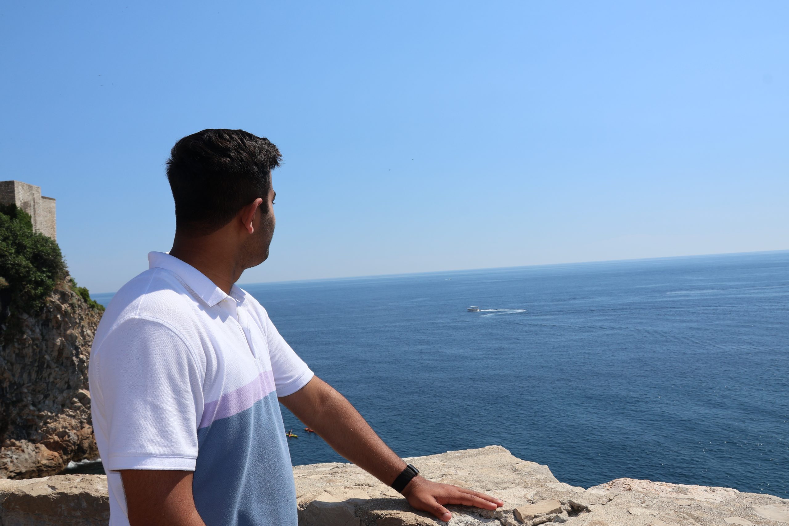 Umer standing and looking out over the Adriatic Sea in Dubrovnik.