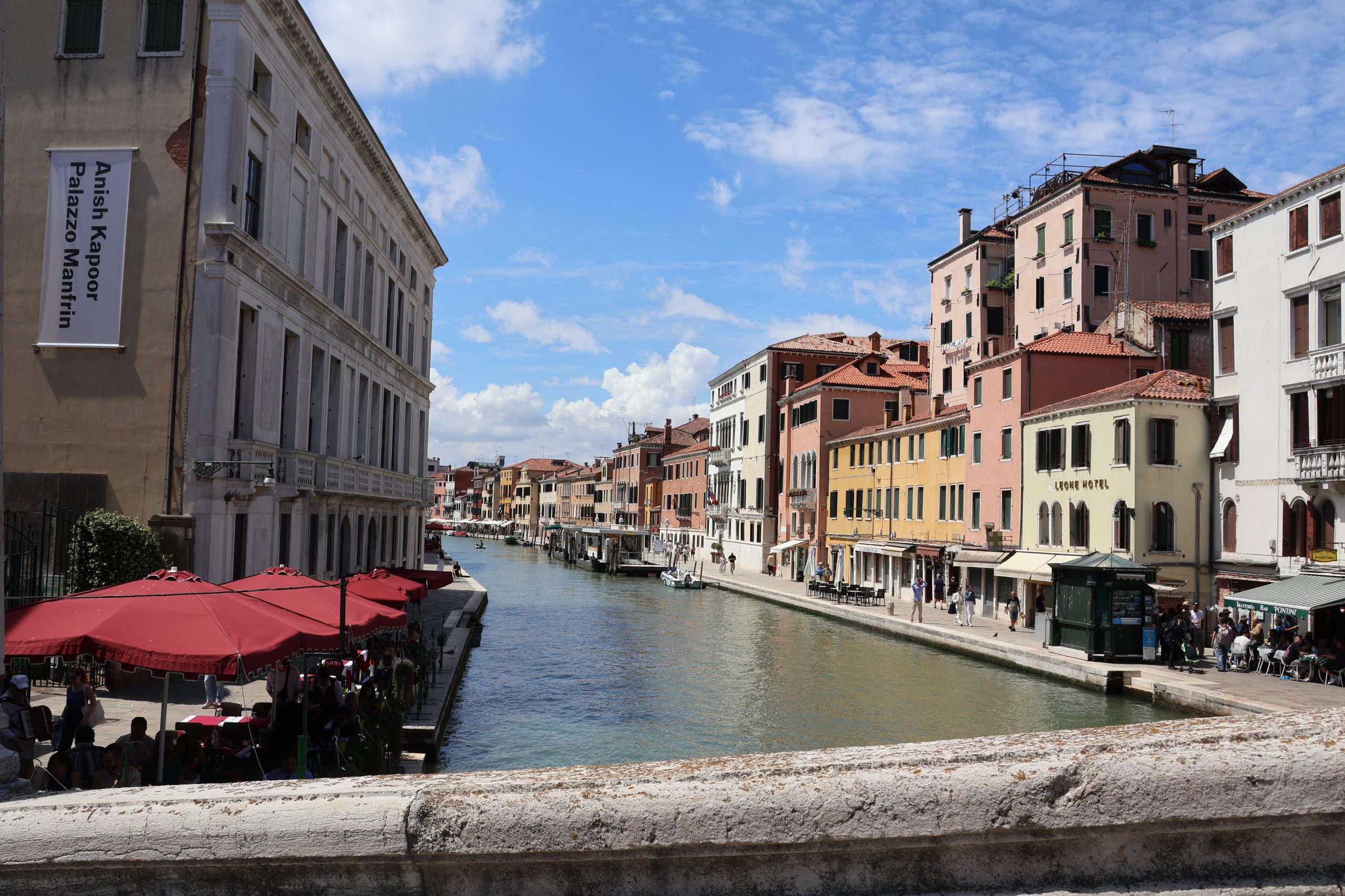 A canal-side street in Venice with buildings lining the water.